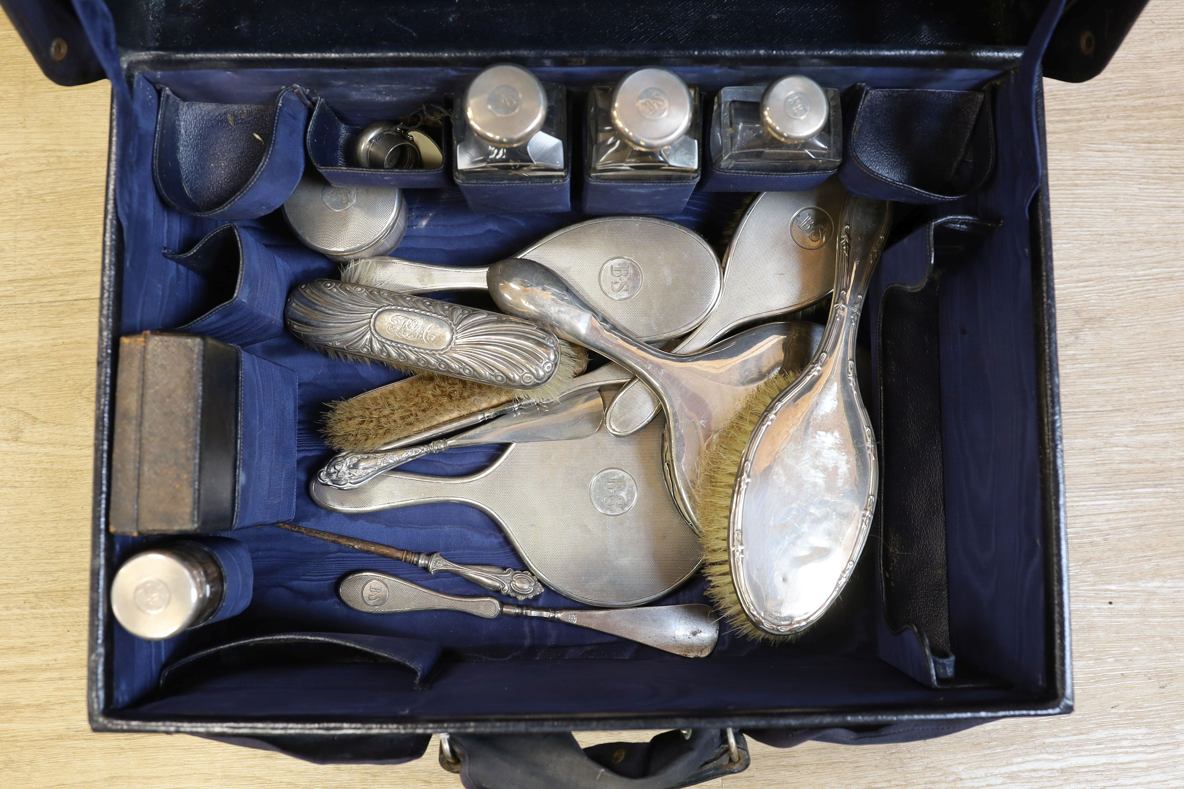 A 1930's part silver mounted glass toilet set , comprising eleven items, London, 1933 in a leather travelling case, together with five other associated accoutrements.